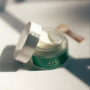 Open Jar of Hydracloud Cream against white background by window light