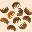 Multiple buffalo horn hand-crafted meridian massage combs with YINA branding on a beige background