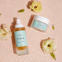 Yina skincare products - Mist and Cloud on a pink textured background with flowers.