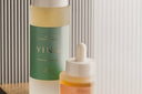 Two YINA skincare products on a wooden surface with a neutral background