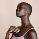 A woman using YINA Gua Sha  on her chest